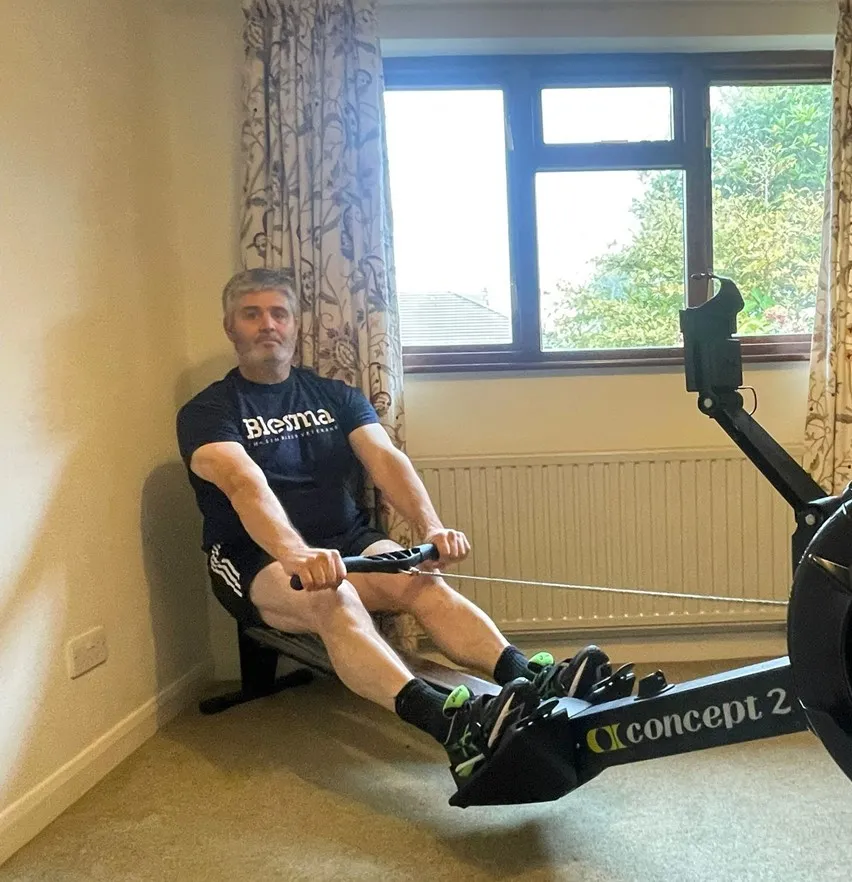 A man on a rowing machine.