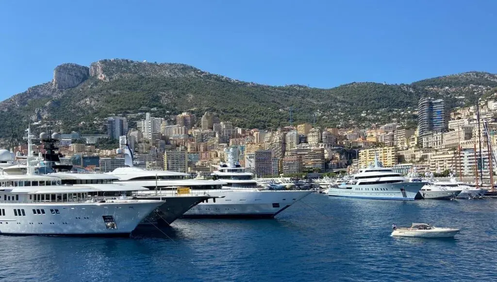 Monaco marina with numerous large yachts docked.