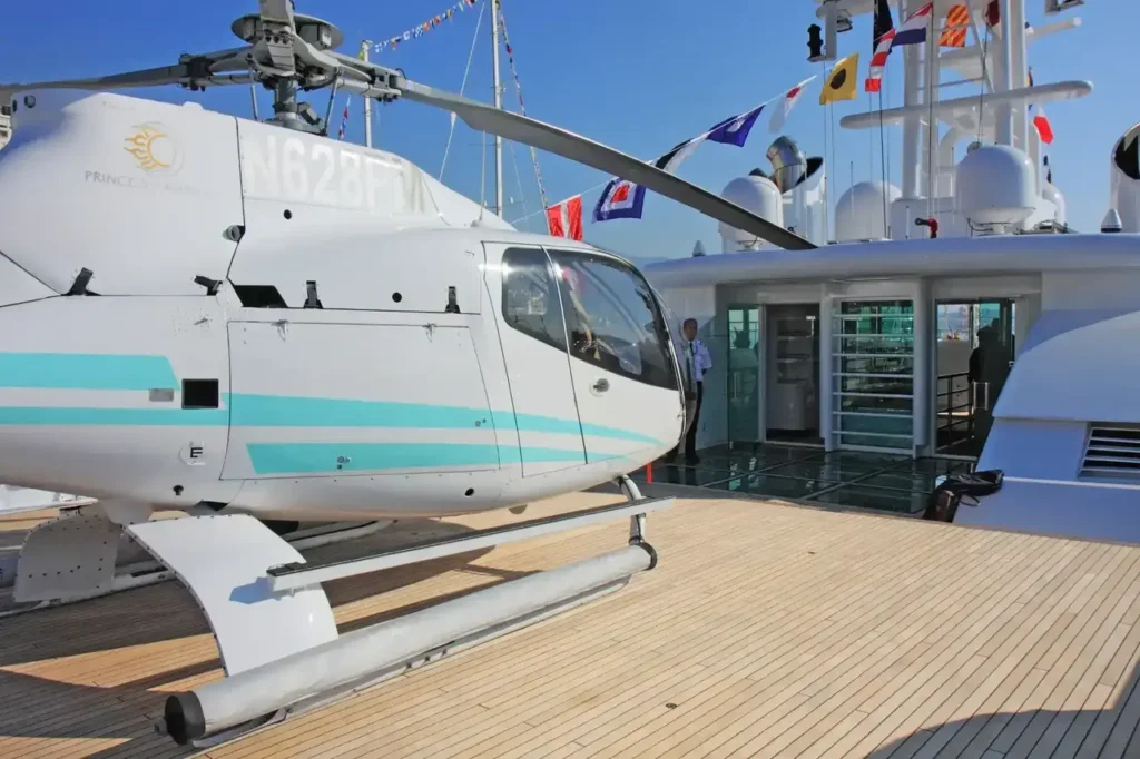 A commercial helicopter parked on a yacht landing pad.