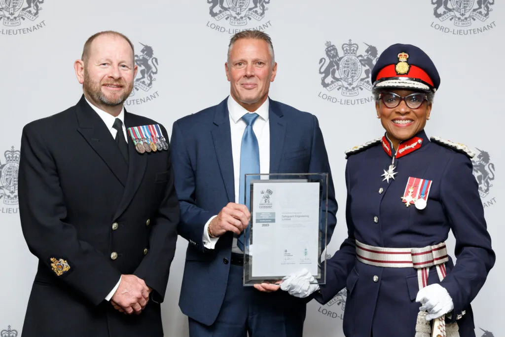 Military personnel presenting an award to Safeguard Engineering.