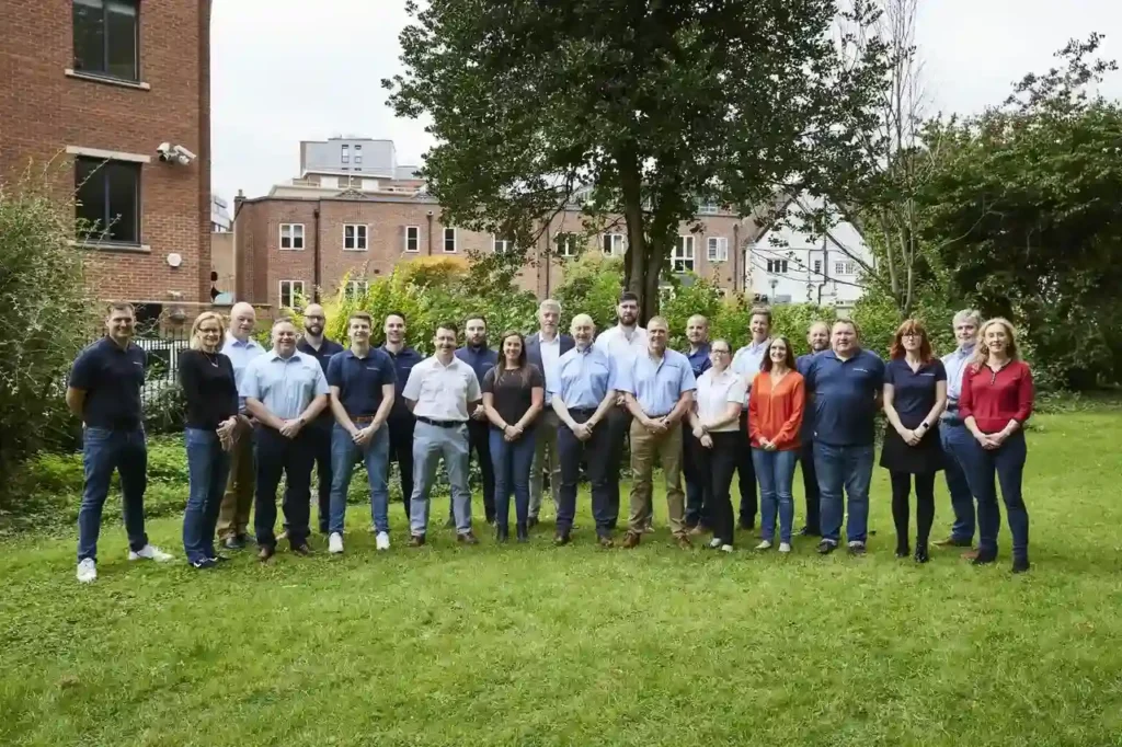 A group of people stood in two lines in a field.