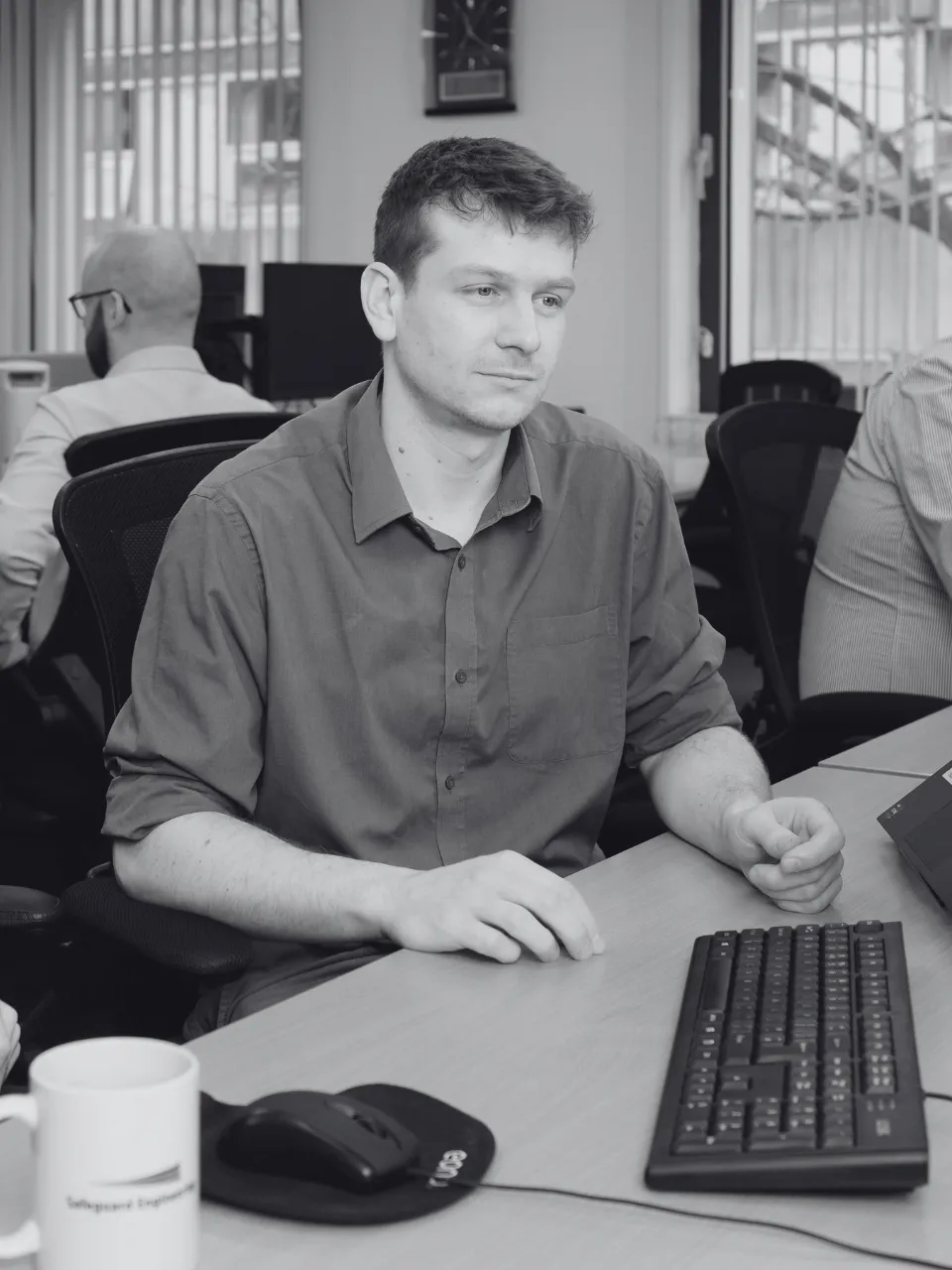 Safeguard team member working at desk.