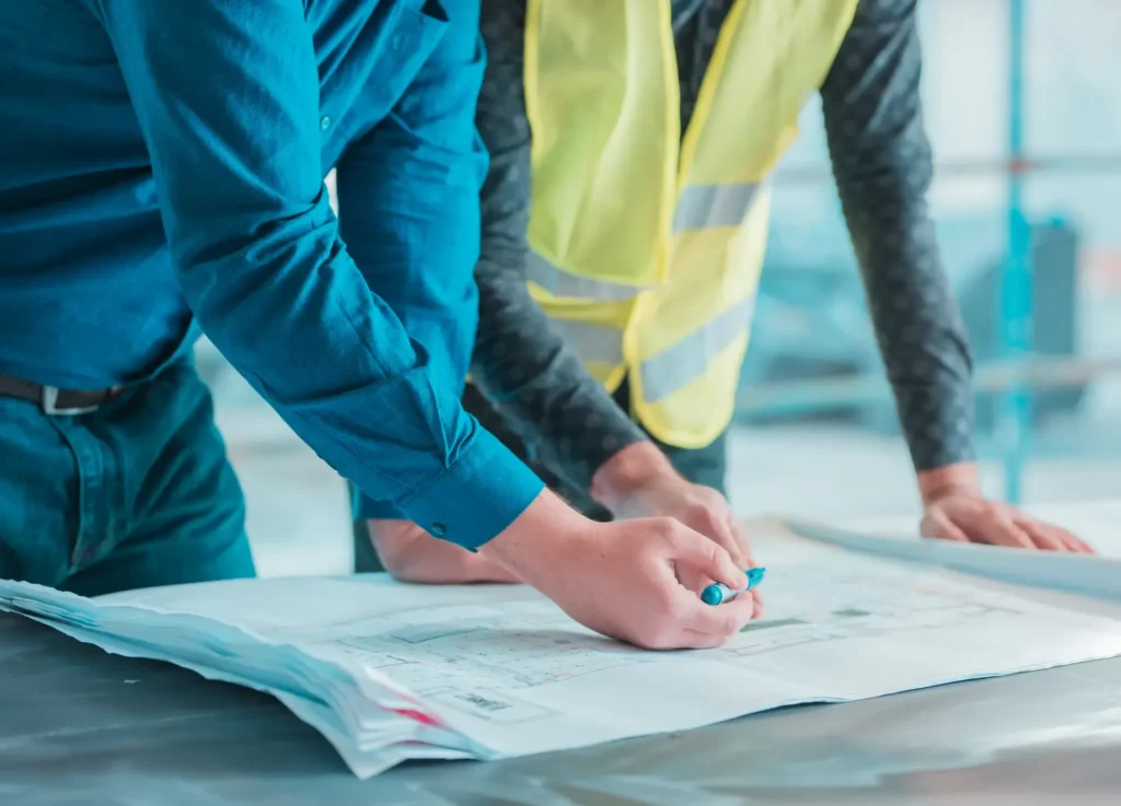 Two architects looking at design plans.